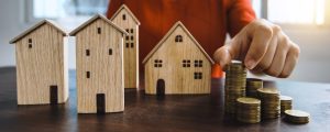 Australian affordable housing crisis: Builders struggle with investment, stacked coins & model homes.