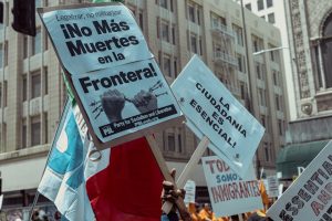 Australian immigration policy protest signs in LA, highlighting national security concerns.