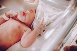 Australian newborn baby in hospital, impacting birth rate. Wellness focus.