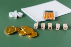 Australian coins, calculator, "taxes" on green. Capital gains tax for investors.
