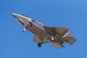 Australian F-35 fighter jet, key to defence & finance impact of AUKUS nuclear submarines.