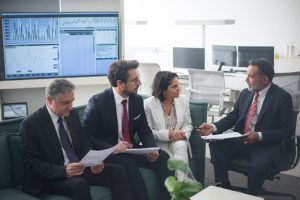 Australian business pros discuss economic vision in modern office podcast.