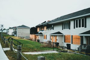 Boarded-up suburban homes, showing neglect, a visual of Australia's housing crisis.
