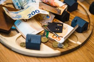 Australian housing tax policy: Euro, keys, houses symbolize finance.