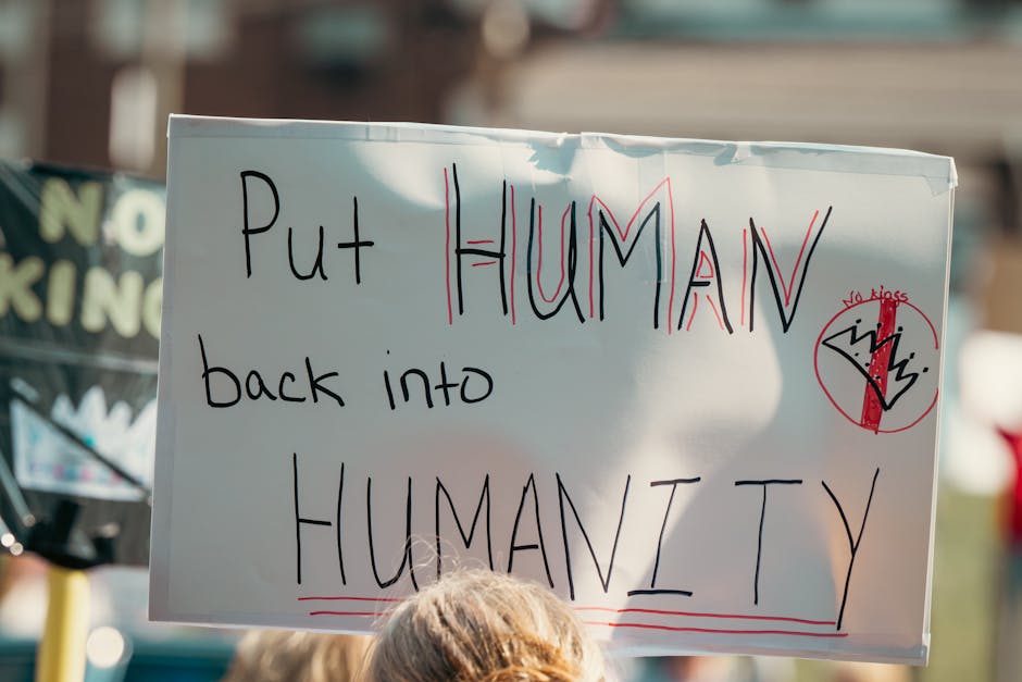 Protest sign 'Put Human back into Humanity' during rally, Australian Liberal Party politics