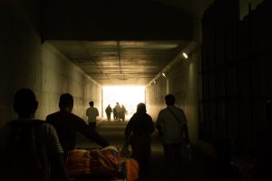 Australian migrant group silhouette exiting a tunnel in India, Pexels