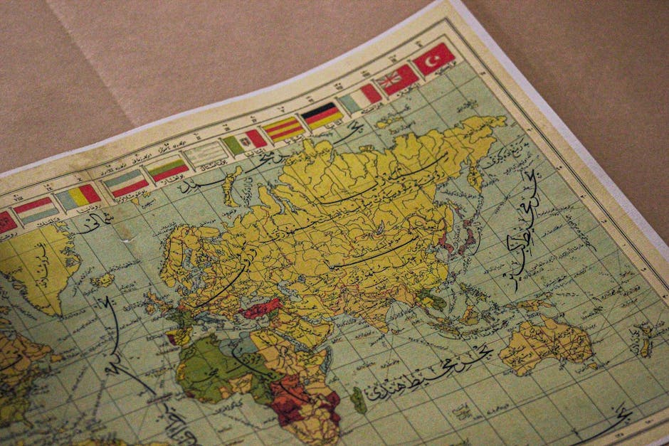 Antique world map showing continents, Arabic script, and various national flags.