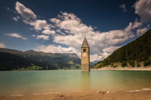 South Tyrol's submerged bell tower, Reschensee, Italy. Iconic bell tower view.