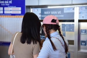 Australian concertgoers avoiding predatory ticket pricing at Ticketmaster kiosk.