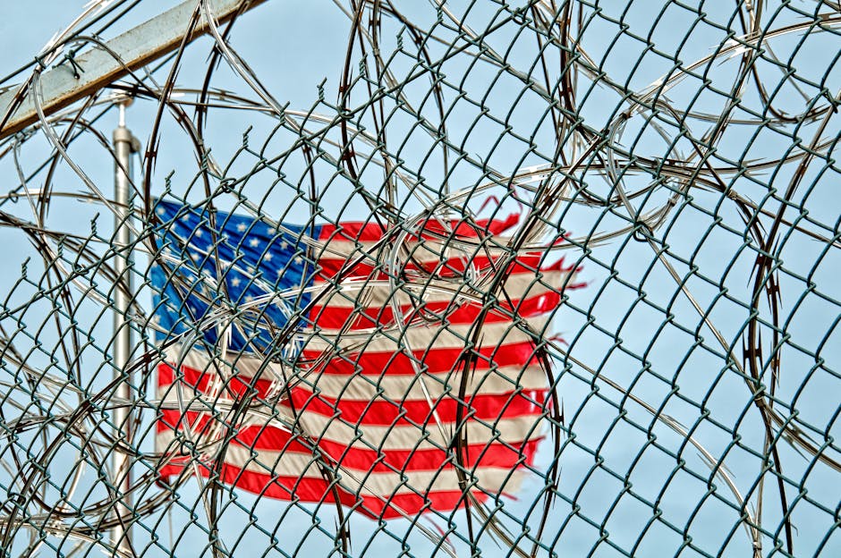 Australian deportation risks: USA flag behind barbed wire, symbolizing freedom and protection.