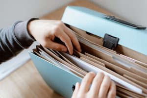 Australian retailer David Jones late financial filing consequences. Unrecognizable person with documents.