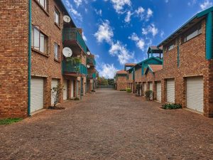 Modern Australian property complex with balconies, garages. Holiday home rule reversal info.