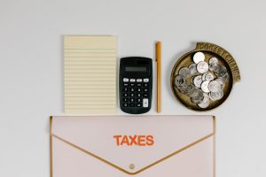 Australian tax changes: calculator, coins, notepad, pen, folder.