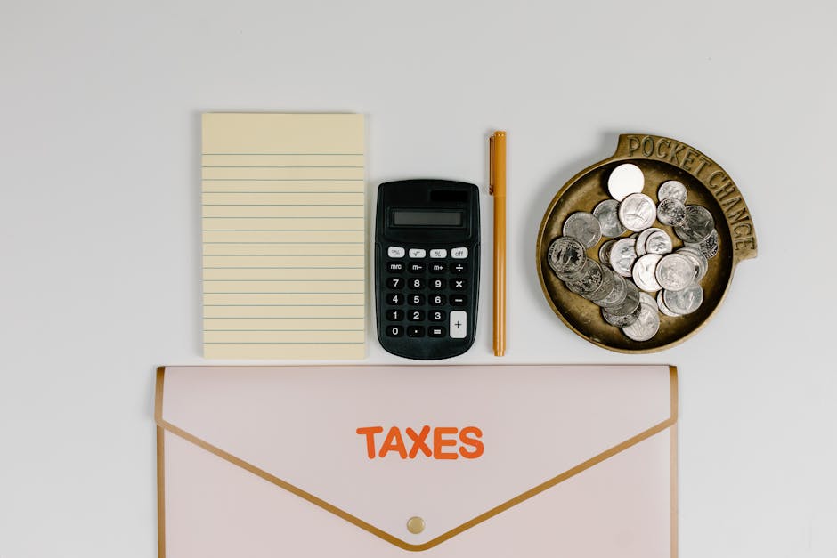 Australian tax changes: calculator, coins, notepad, pen, folder.